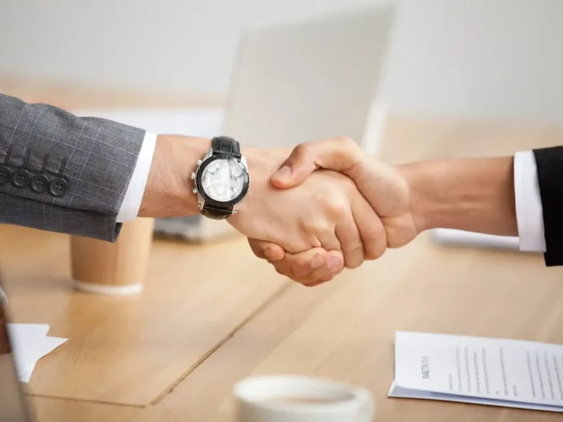 closeup-view-handshake-two-businessmen-suits-shaking-hands-1-scaled-optimized