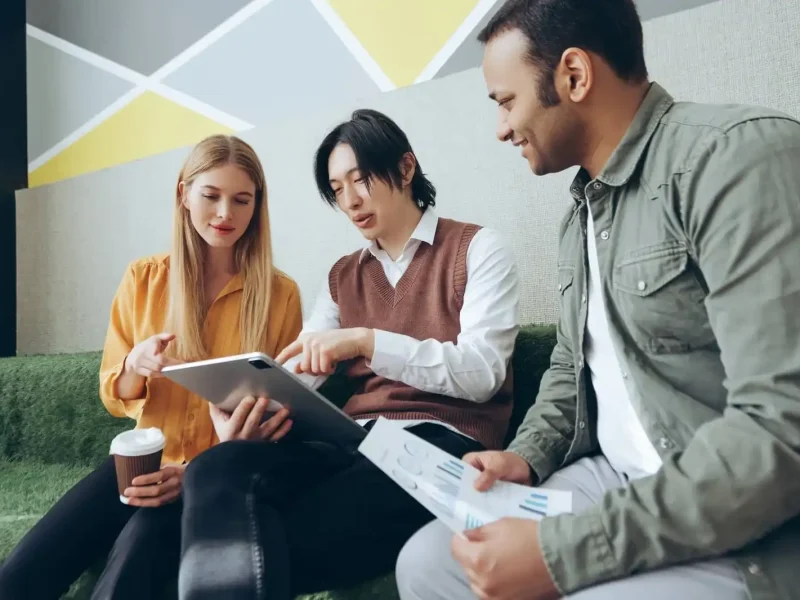 marketing-team-analyzing-data-and-working-on-digital-tablet-and-documents-optimized